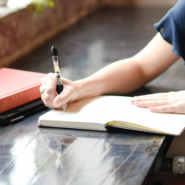woman writing in notebook